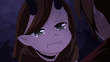a demon girl with horns is crying and making a funny face