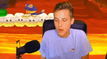 a man wearing a nike t-shirt sitting in front of a microphone