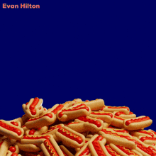 a bunch of hot dogs on a blue background with the name evan hilton on it