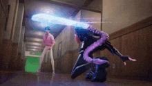 a man in a pink shirt is standing in a hallway next to a woman with a purple tail .