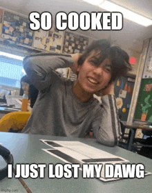 a man sits at a desk with his hands behind his head and a meme that says so cooked