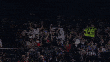 a wrestler in a ring holds up a sign that says casa franco