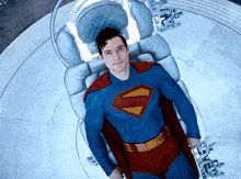 a man in a superman suit is laying down