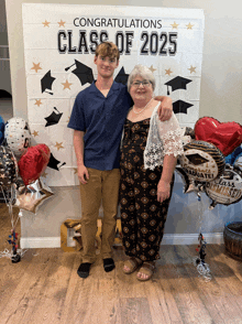 a boy and a woman are posing in front of a sign that says congratulations class of 2025