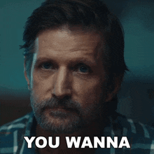 a man with a beard has the words you wanna on his face