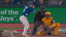 a blue jays player is running towards home plate
