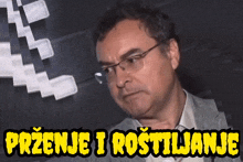 a man wearing glasses stands in front of a sign that says " przenje i rostiljanje "