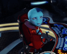 a cartoon character is sitting in a red chair with a steering wheel