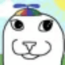 a white cat wearing a rainbow hat on its head .
