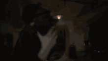 a blurry picture of a man in a dark room holding a gun