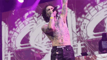 a shirtless man is singing into a microphone while wearing underwear that says dcn
