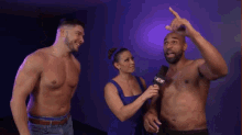 a man without a shirt is being interviewed by a woman with a microphone that says a & w on it