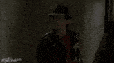 a man is standing in front of a door with the words a chick written on it .