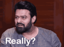 a man with a beard is making a funny face and says really