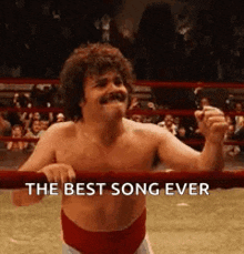 a shirtless man in a wrestling ring with the words `` the best song ever '' written on the bottom .