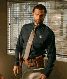 a man in a police uniform has a badge that says sheriff