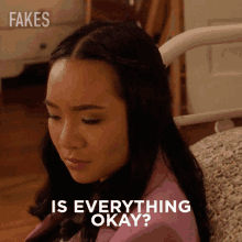 a woman is sitting on a couch with the words " is everything okay " below her
