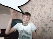 a boy with a speech bubble above his head is wearing a shirt with a unicorn on it