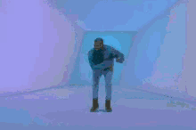 a man in a blue jacket is dancing in a room with purple walls .