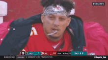 a man wearing a headband with a kc on it