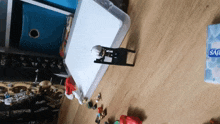 a box of tissues sits on a wooden floor