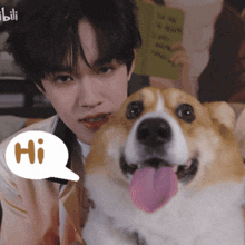 a man holding a dog with a speech bubble saying hi