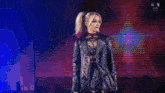 two female wrestlers are standing next to each other on a stage .