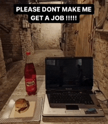 a laptop and a bottle of powerade sit on a table