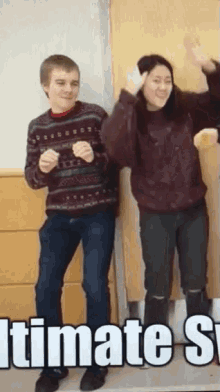 a boy and a girl are dancing in front of a sign that says " ultimate "