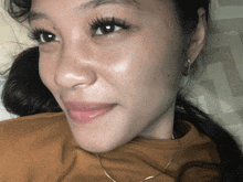 a close up of a woman 's face with a ponytail