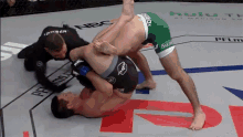 two men are wrestling in a ring with nbc written on it