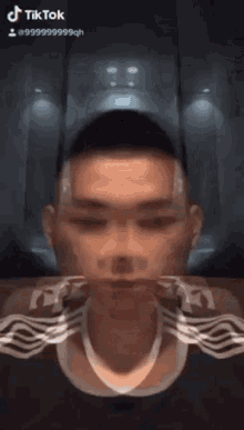 a man is sitting on a couch and making a funny face with his eyes closed .