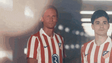two men wearing red and white striped shirts with the letter r on them