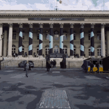 a large building with columns and a banner that says multivers
