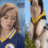 a woman in a cheerleading uniform is standing next to a dog wearing a yellow hoodie .