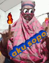 a person wearing a pink scarf and sunglasses has aku sopo written in blue