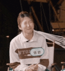 a woman sitting in a chair with her eyes closed and a name tag that says wyor