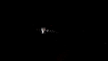 a group of people are standing in a dark room in front of a sign that says exit .