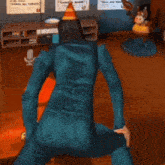 a man in a blue jumpsuit is dancing in front of a box that says pq on it