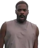 a man with a beard is wearing a tank top and making a funny face