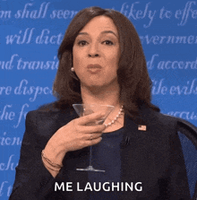 a woman is holding a martini glass and laughing