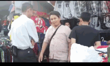 a group of men are standing in front of a store talking to each other