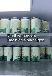several cans of saigon lager are lined up on a shelf