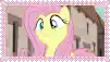 a close up of a cartoon pony with a pink background .