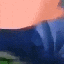 a blurred image of a person 's torso with a blue background