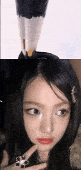 a close up of a woman 's face with a ring on it
