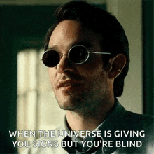 a man wearing sunglasses is giving a speech .