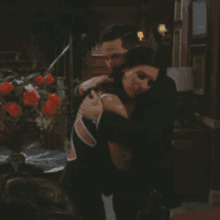 a man and woman hugging in a living room