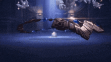 a person is laying on the floor in a dark room with a bird flying in the background