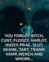 a man in a white shirt is standing in a dark room with a quote that says you forgot bitch